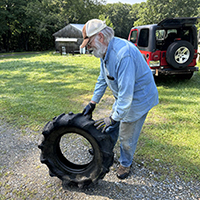 STM Member Ken Slater disposing of an old tire.